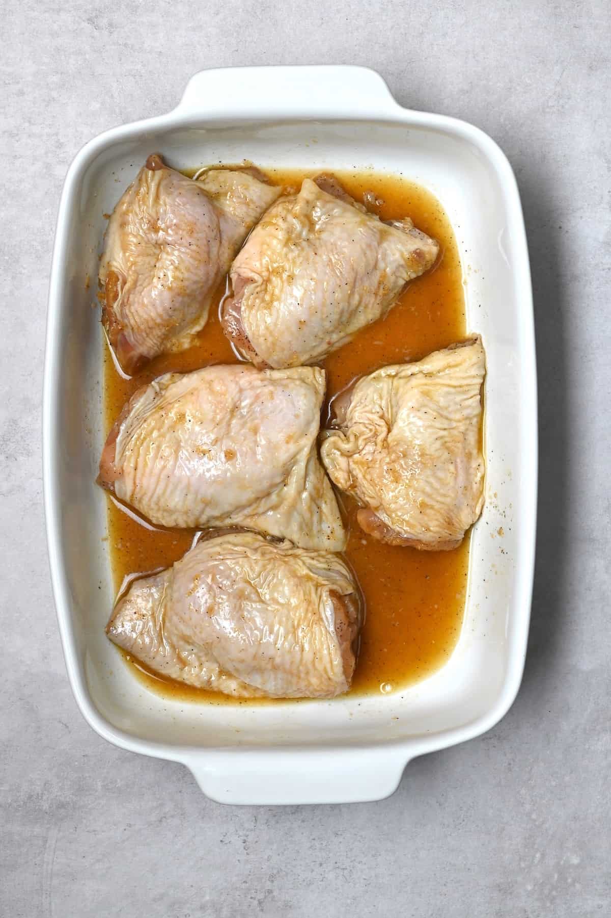 Chicken thights marinating in a sauce