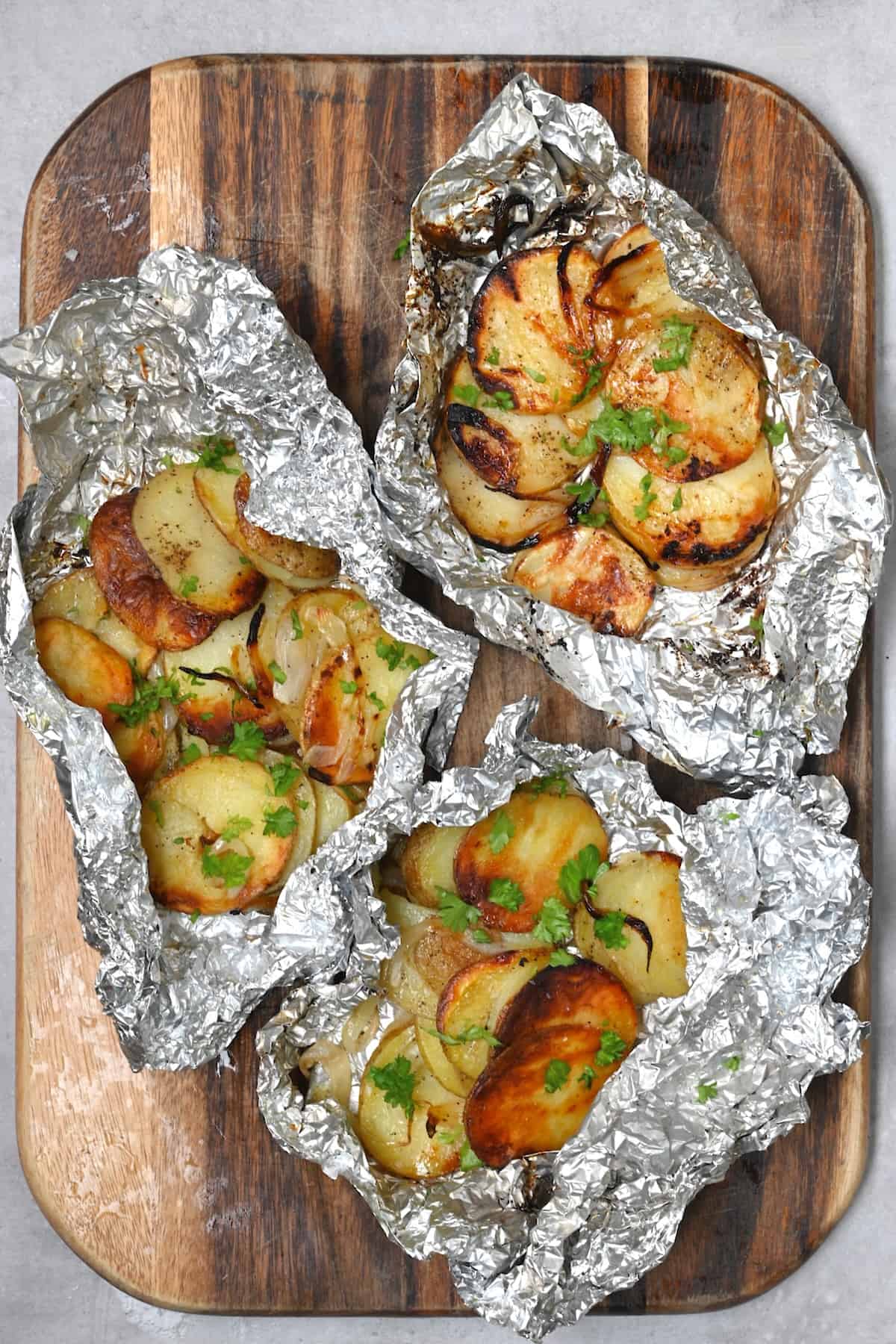 Three packets of grilled potatoes