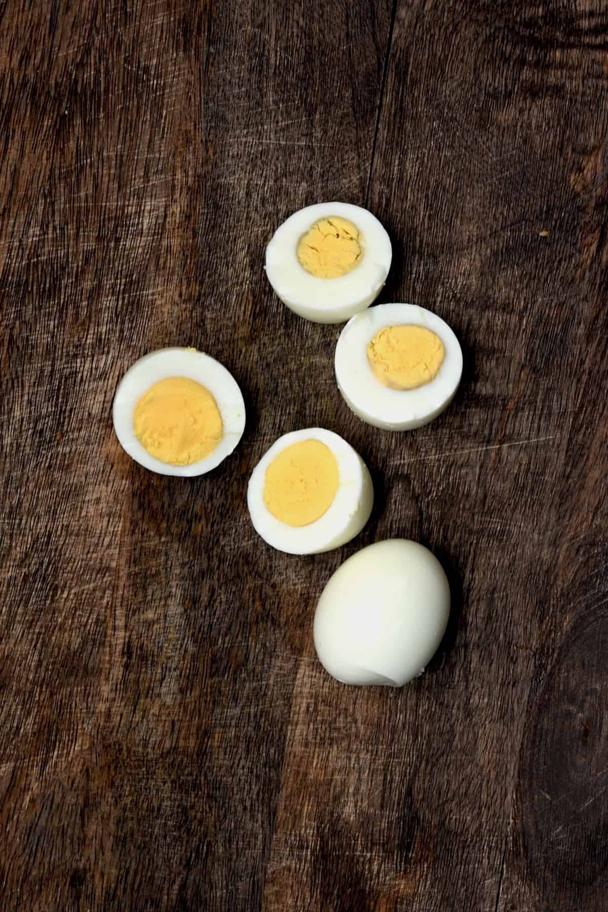 Three hard boiled eggs two of which are cut in half