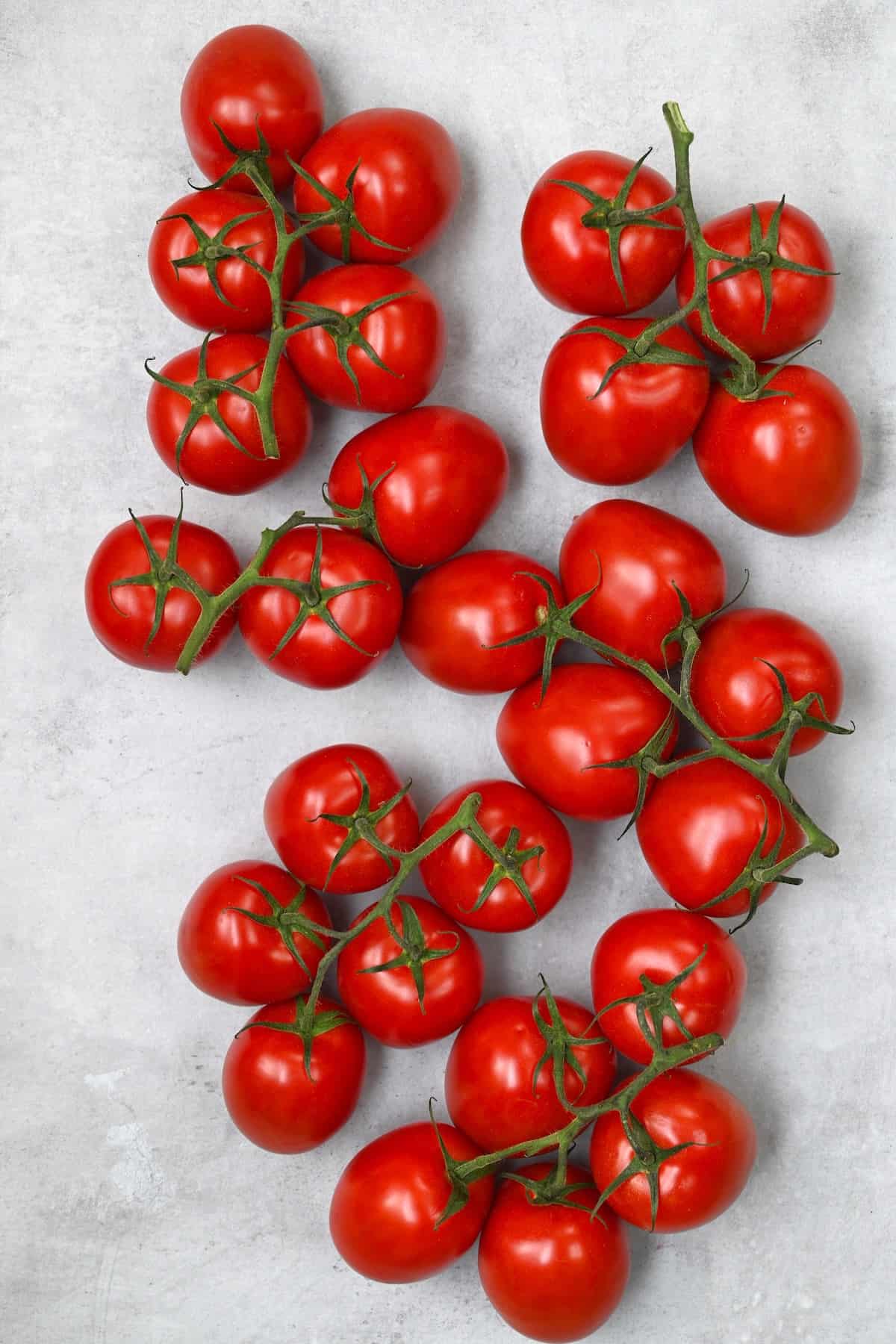 A bunch of tomatoes on a flat surface