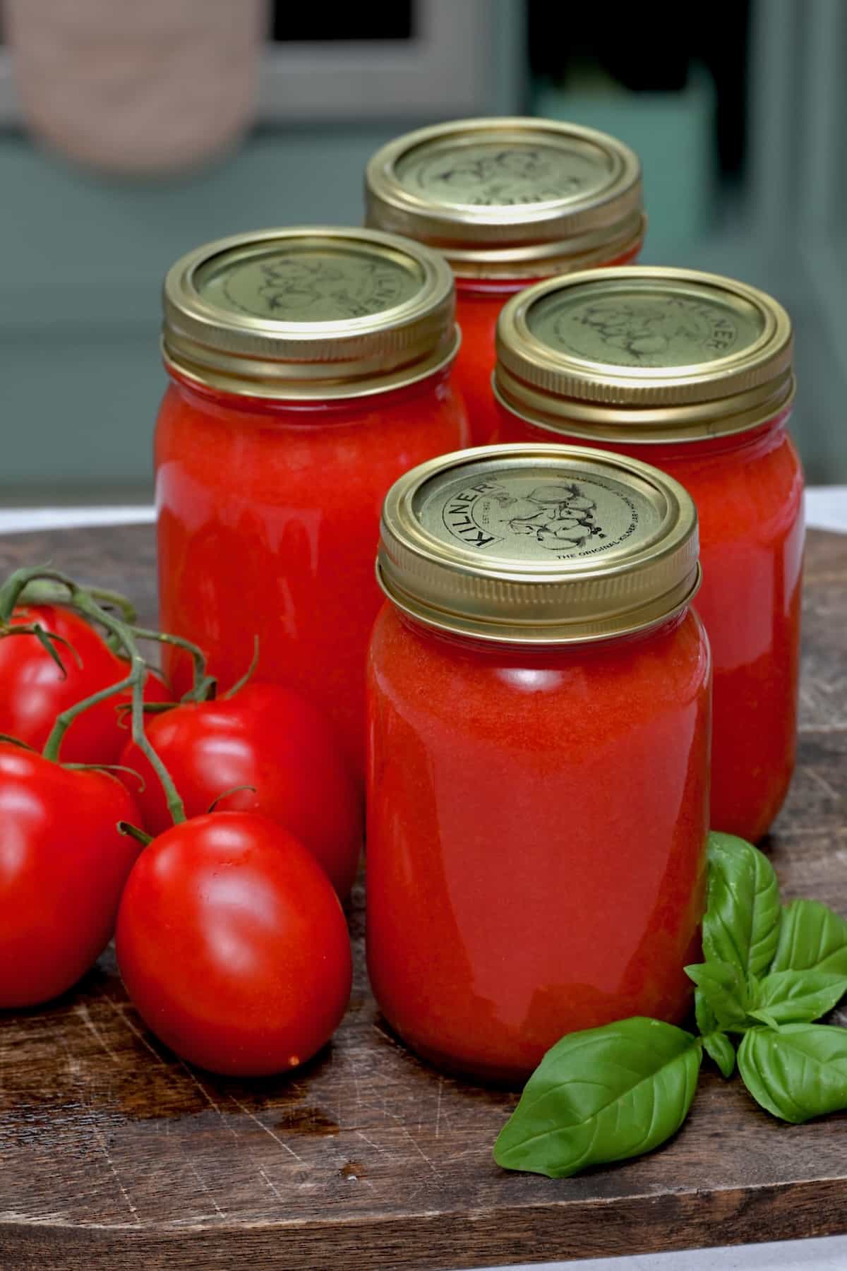 Four jars with homemade tomato puree