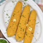 Boiled corn on the cob topped with butter and herbs - 17