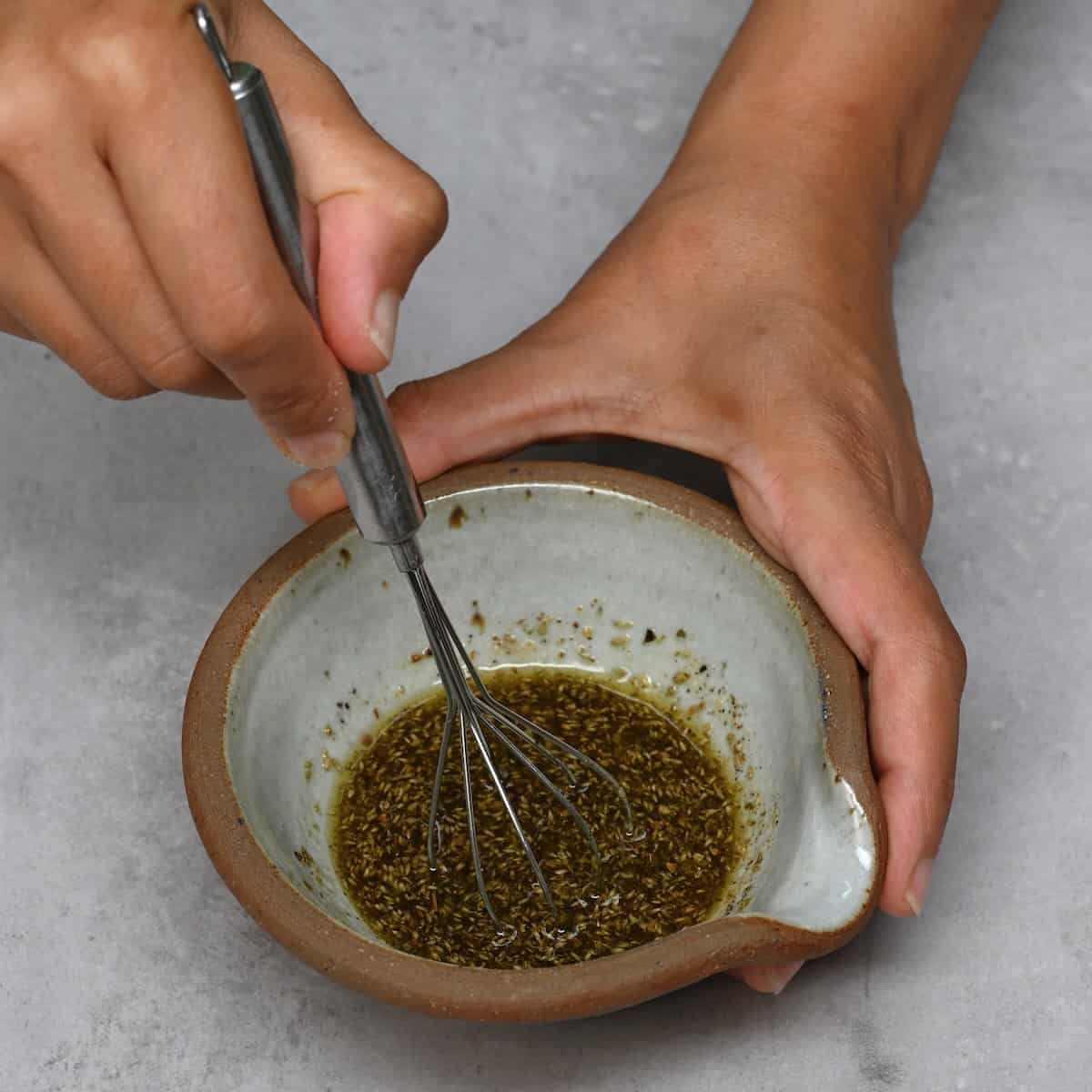 Mixing oil with spices in a bowl