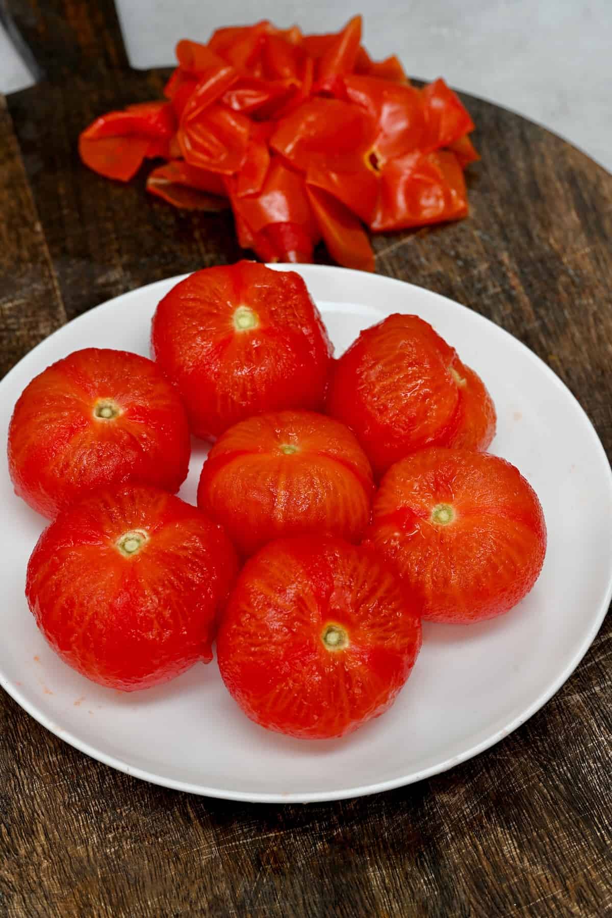 Peeled tomatoes and discarded tomato skin