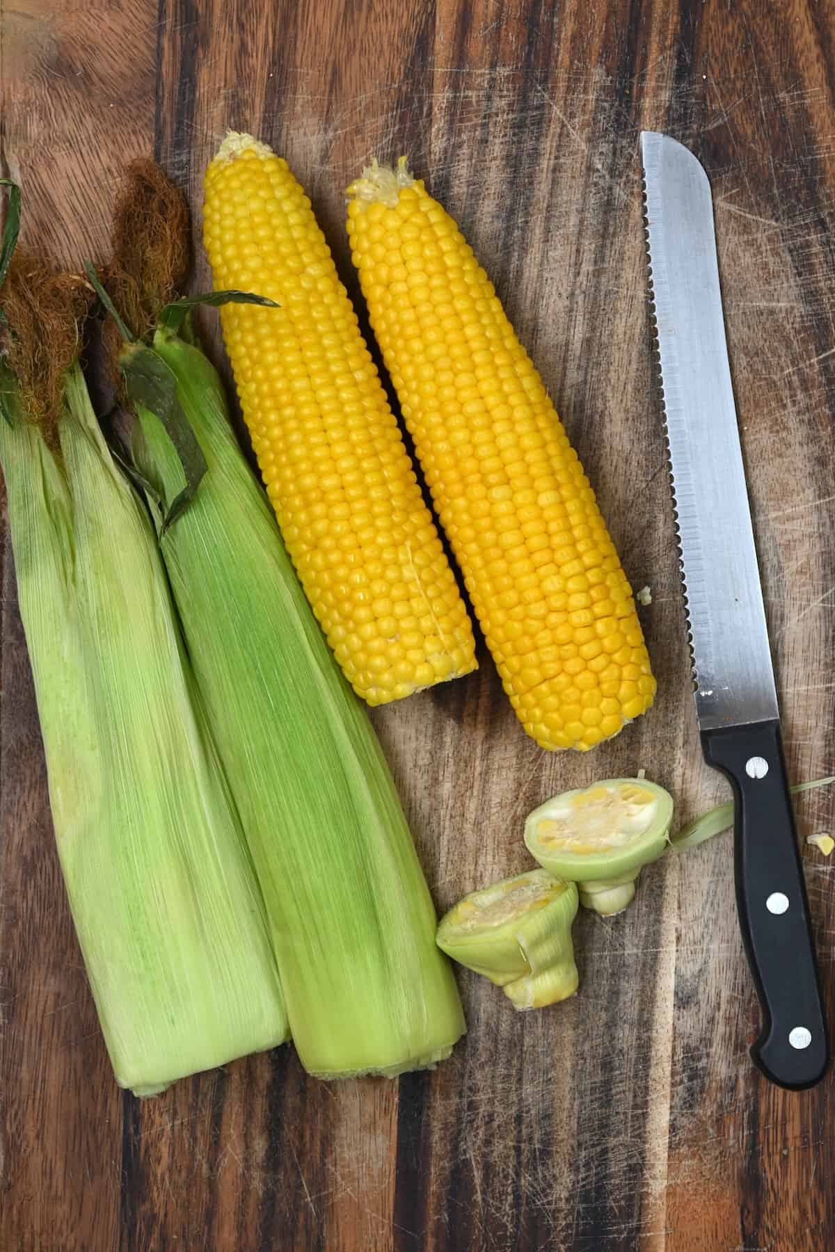 Microwaved corn and its husk on a cutting board