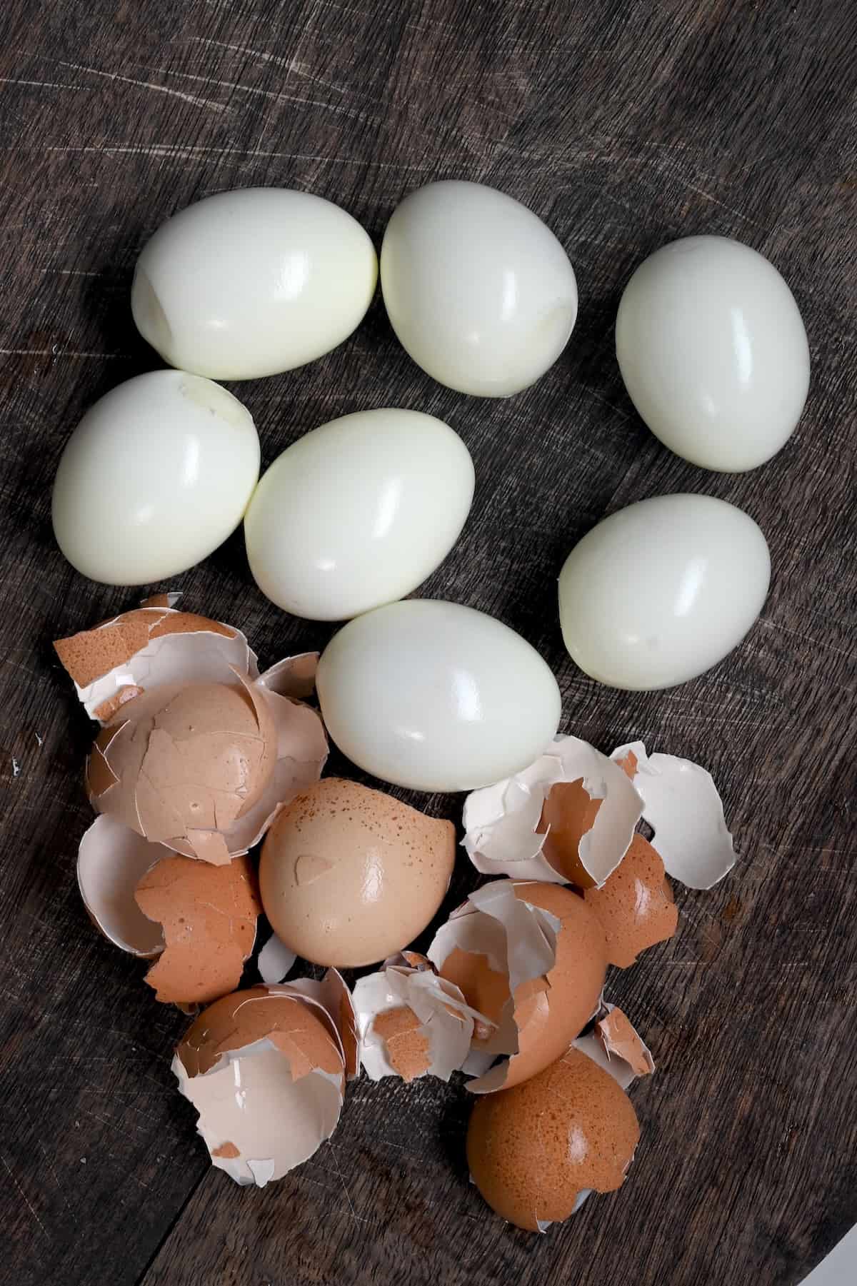 Seven peeled hard boiled eggs