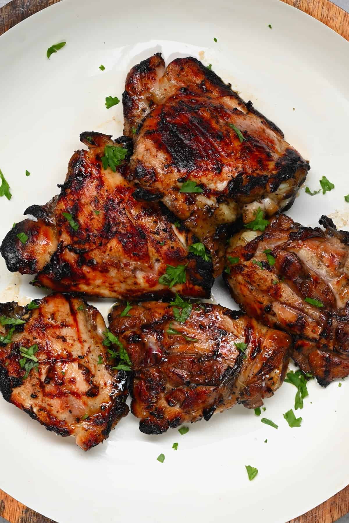 Grilled chicken thighs with skin on in a plate