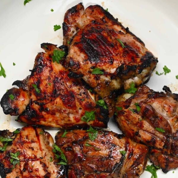Grilled chicken thighs with skin on in a plate