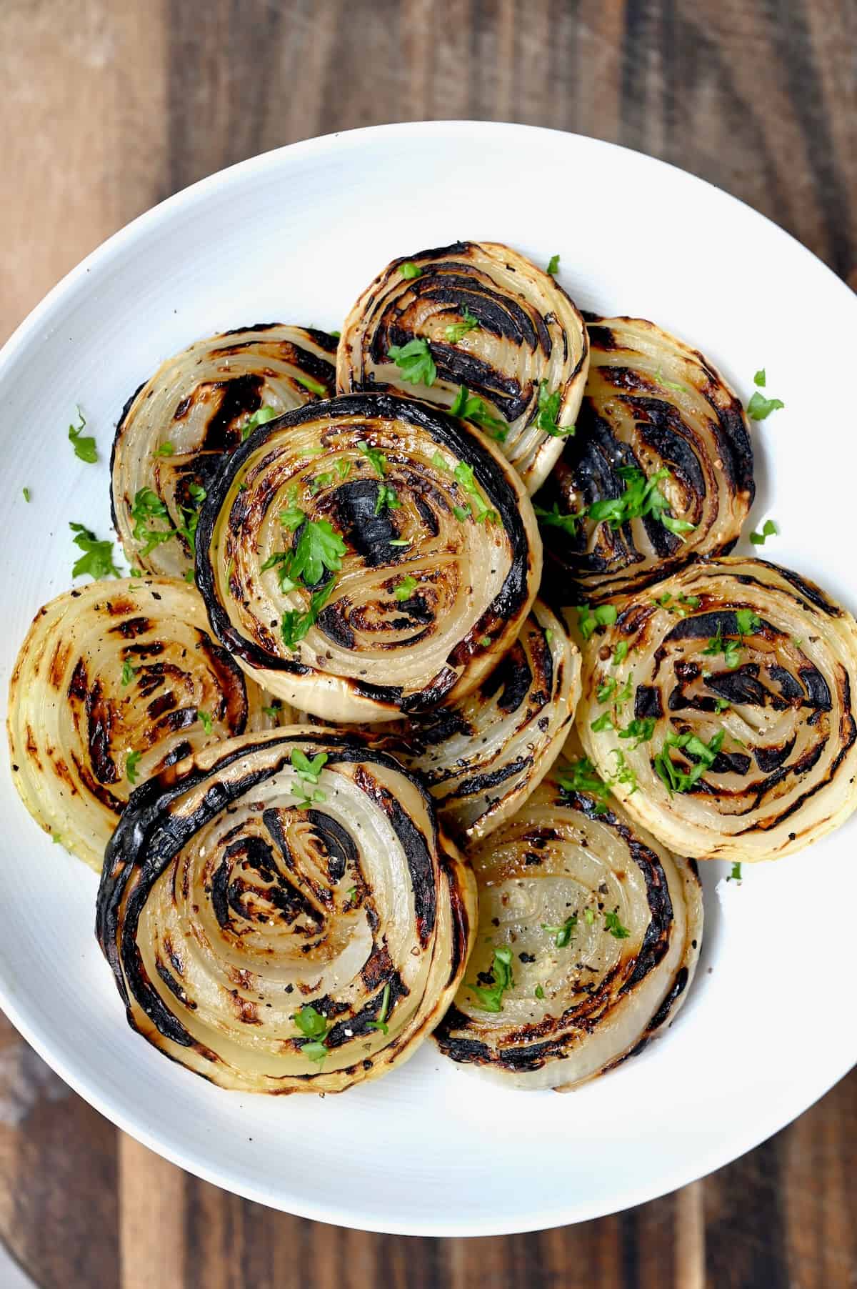 Grilled onions topped with parsley
