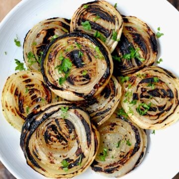 Grilled onions topped with parsley