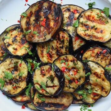 Grilled eggplant slices in a bowl