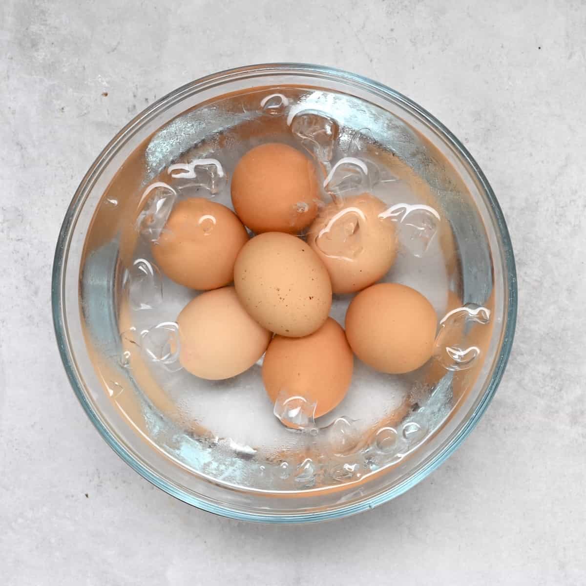 Boiled eggs in a bowl with iced water