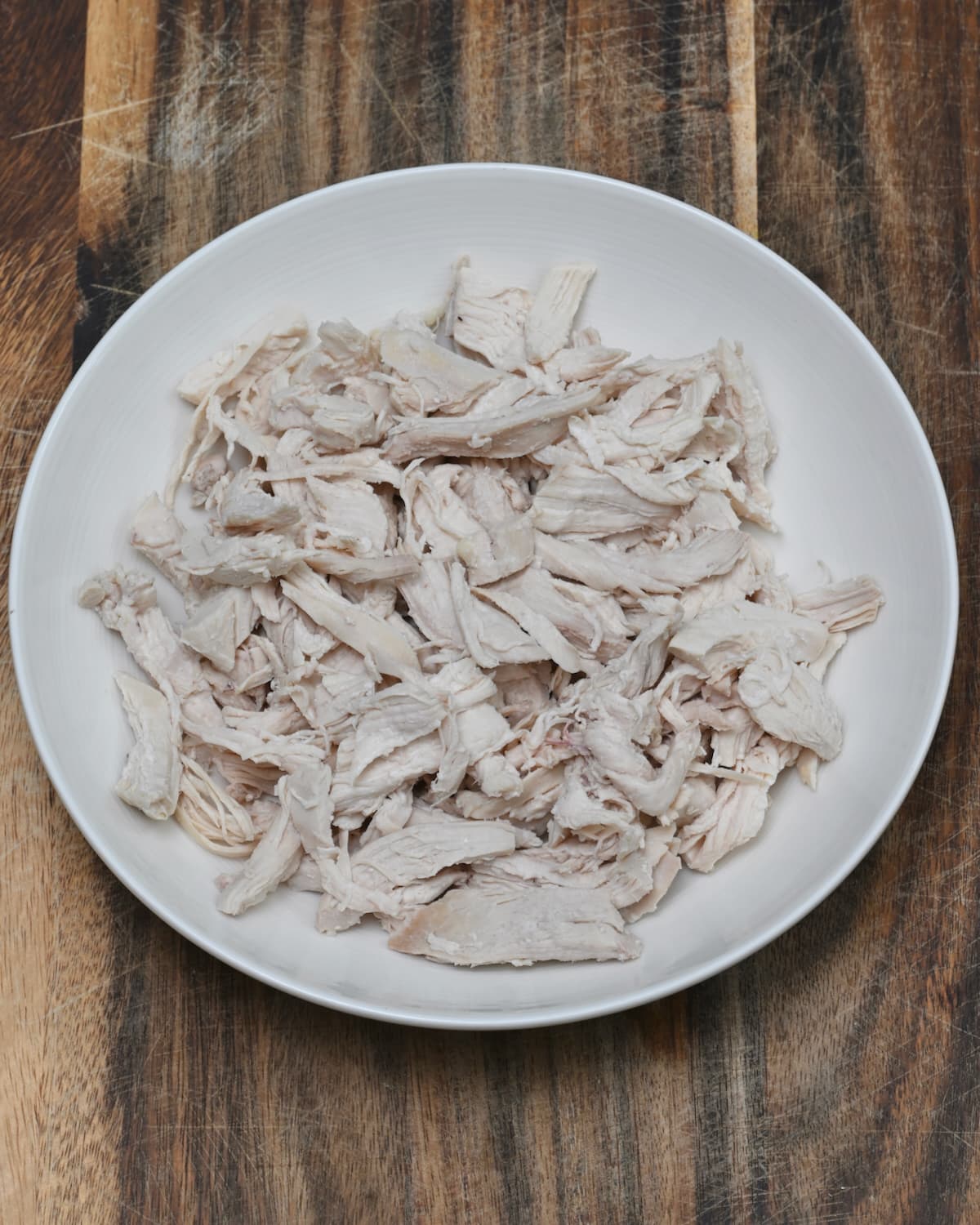 A bowl with shredded boiled chicken