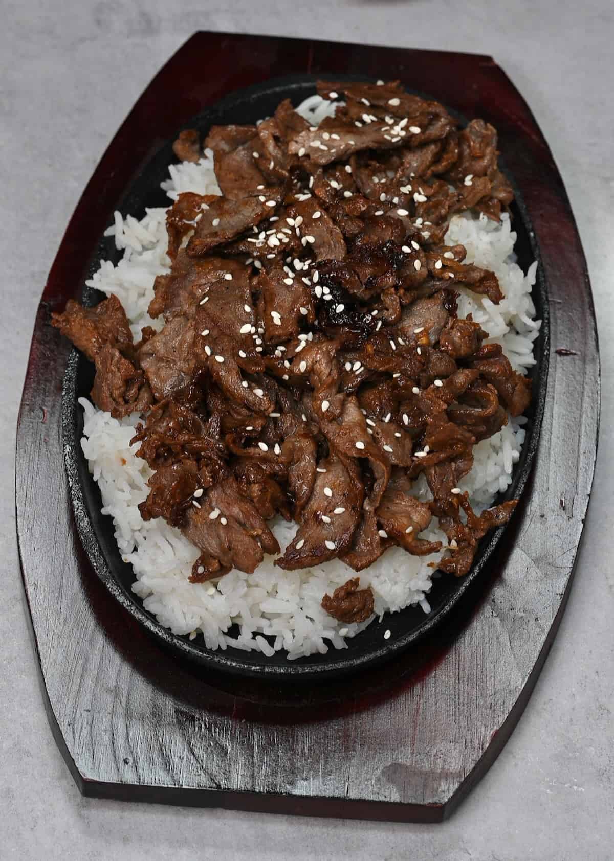 A serving of Korean beef over rice topped with sesame seeds