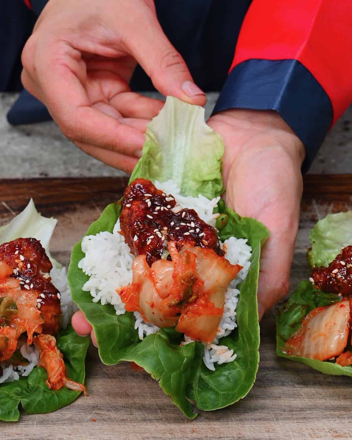 Korean fried chicken served into a lettuce wrap with kimchi