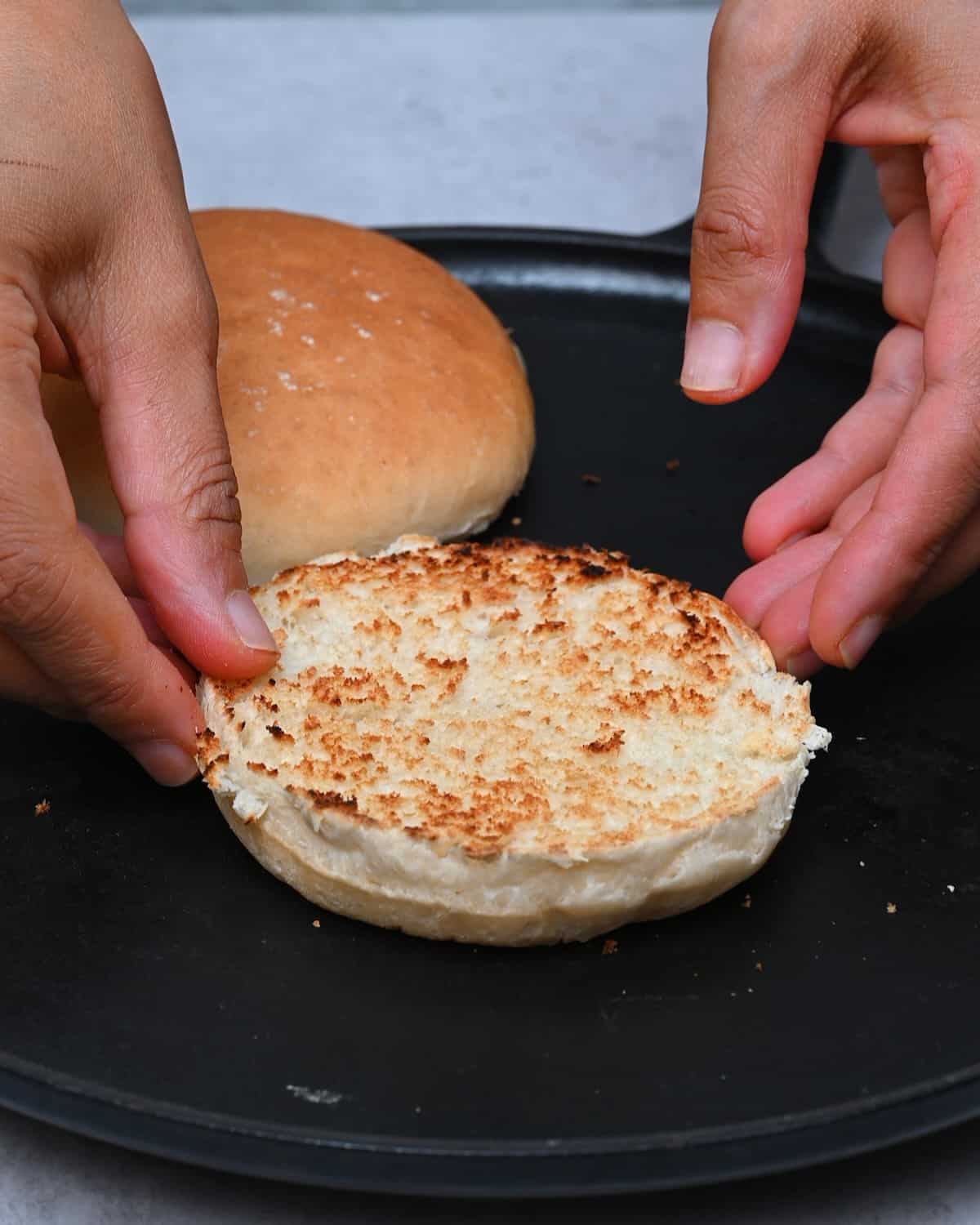 Toasting hamburger buns on dry pan
