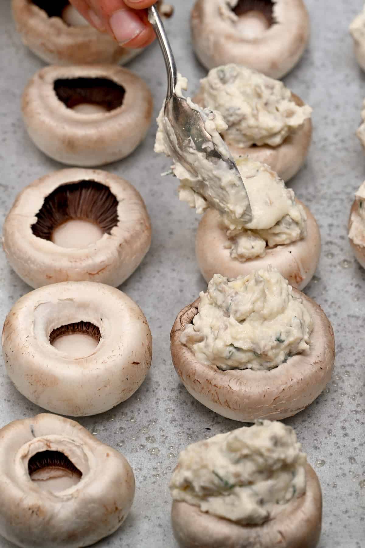 Adding stuffing to mushroom caps