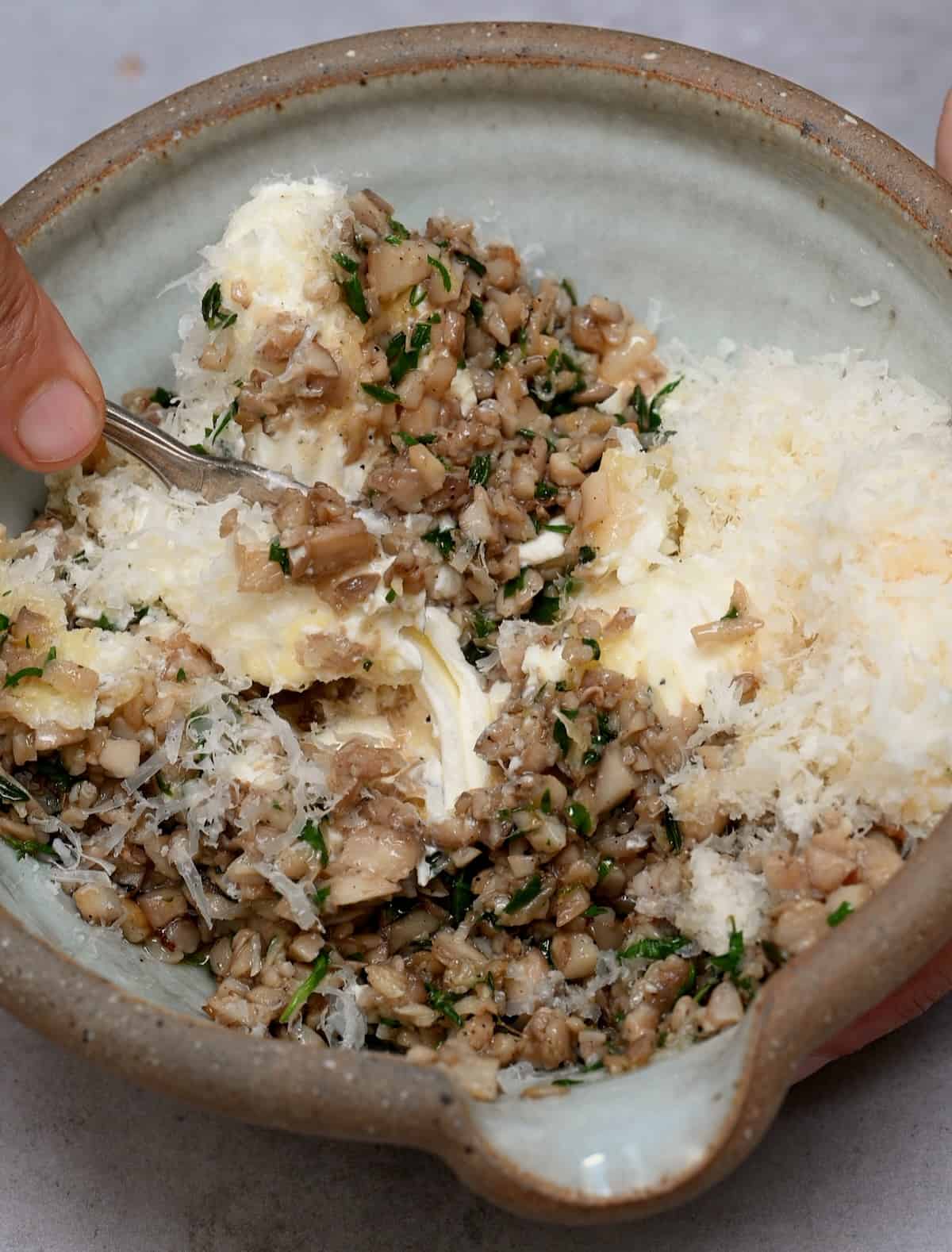 Mixing mushroom stuffing in a bowl