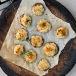 A platter with baked stuffed mushrooms topped with parmesan - 15