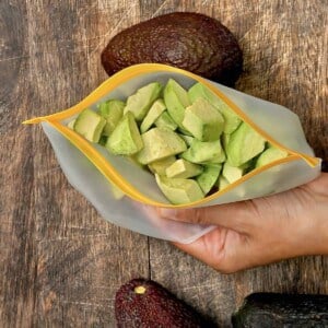 A reusable freezer bag with frozen avocado chunks