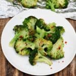 A serving of grilled broccoli topped with chili flakes - 13