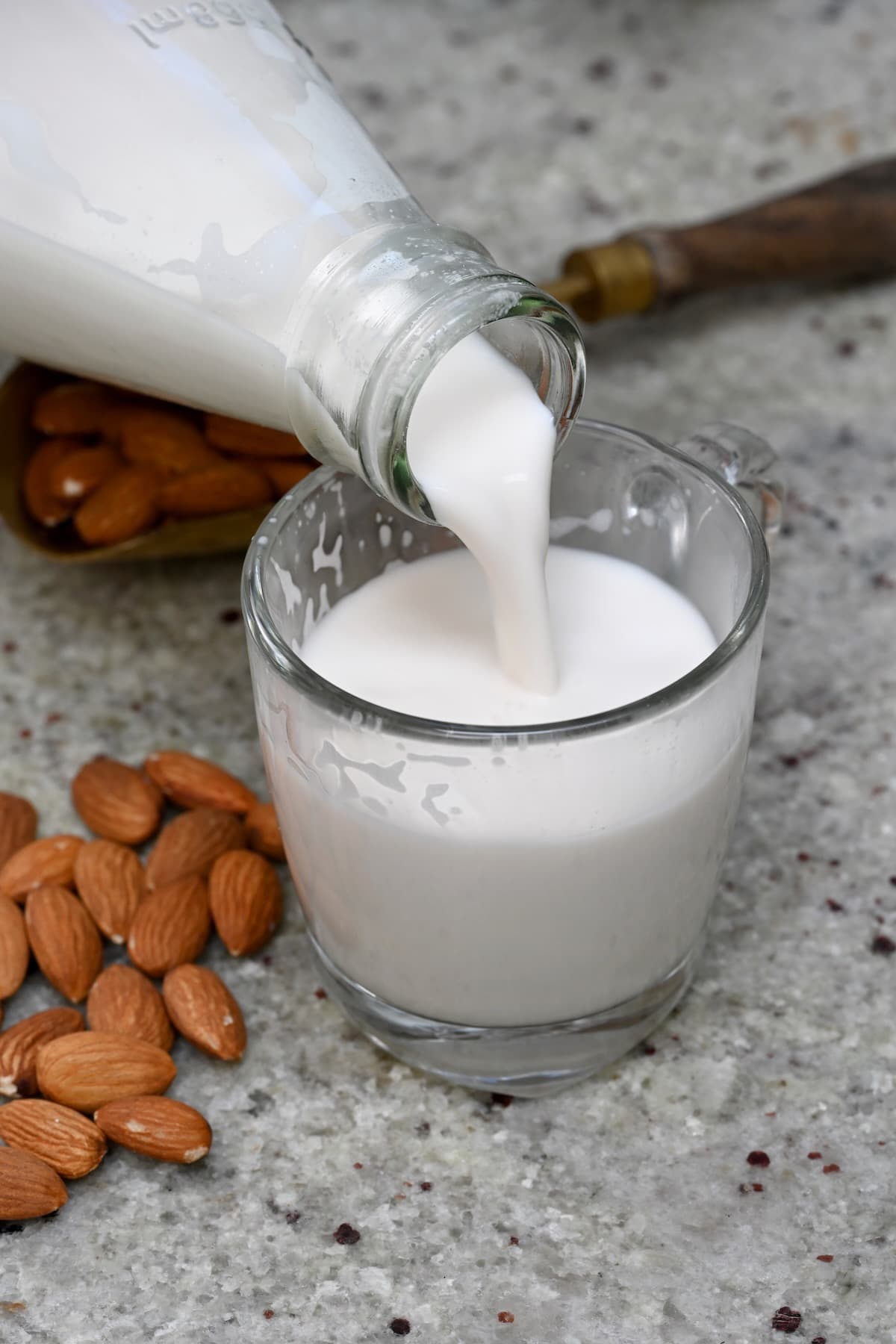 Pouring homemade almond milk in a glass