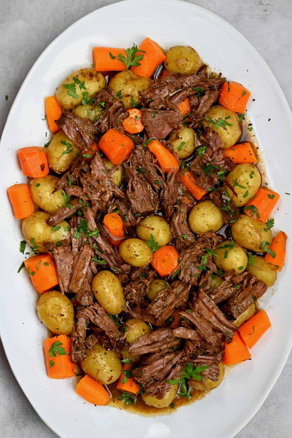Chuck roast with potatoes and carrots on a serving plate