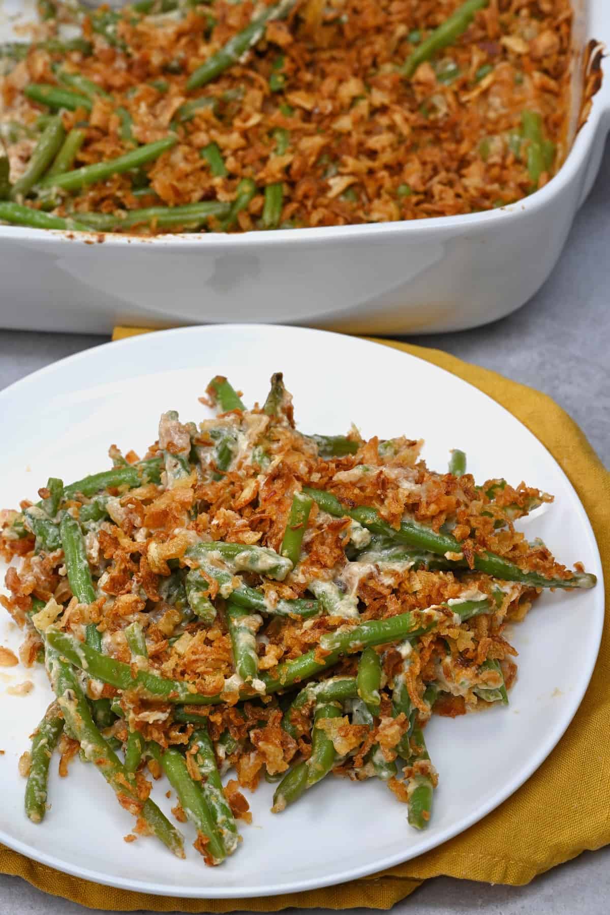 A serving of green bean casserole topped with crispy onions