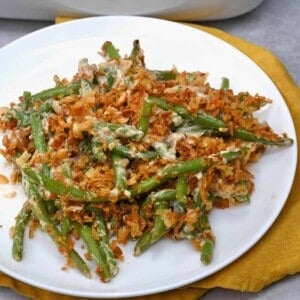 A serving of green bean casserole topped with crispy onions