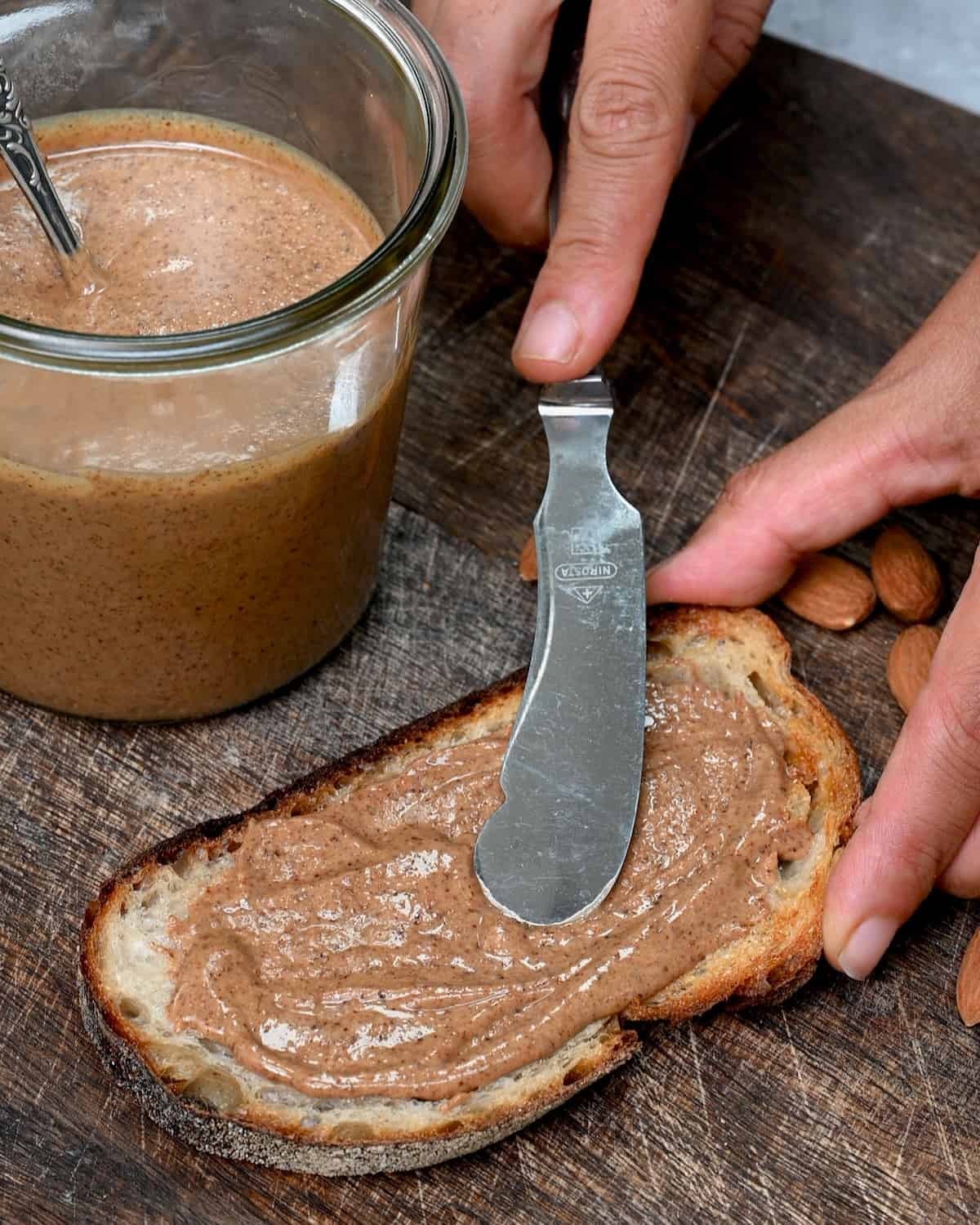 Spreading almond butter on toast