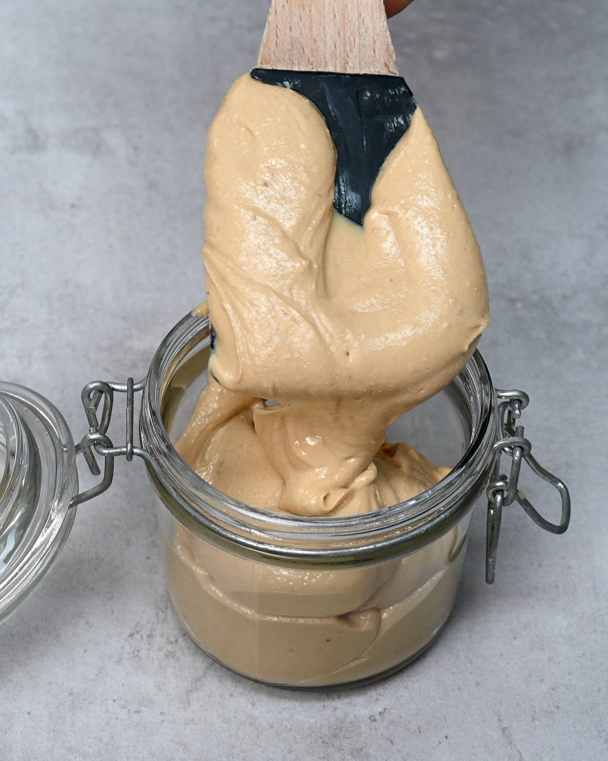 Filling a jar with cashew butter made at home