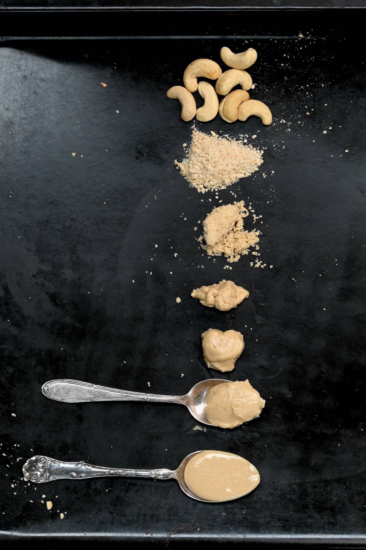 Different stages of blending roasted cashews - from flour to runny butter