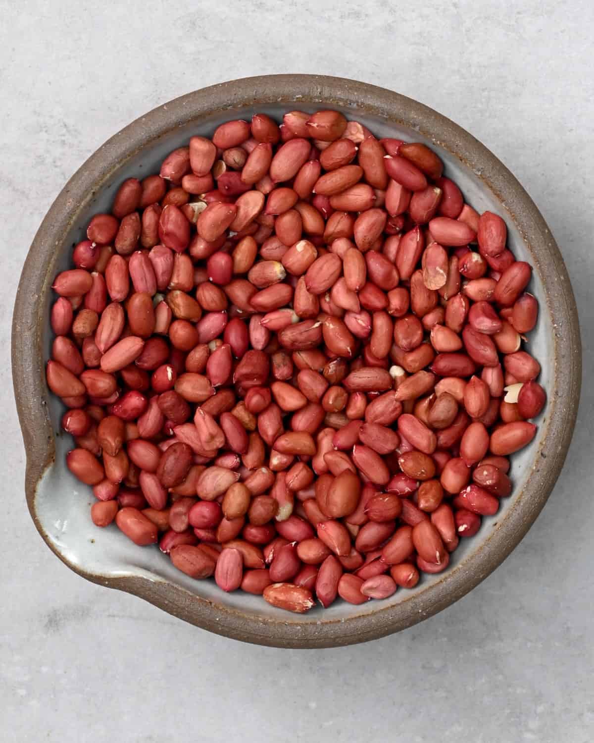 A bowl with raw peanuts
