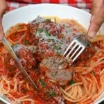 Italian meatballs and pasta dish, checked with fork