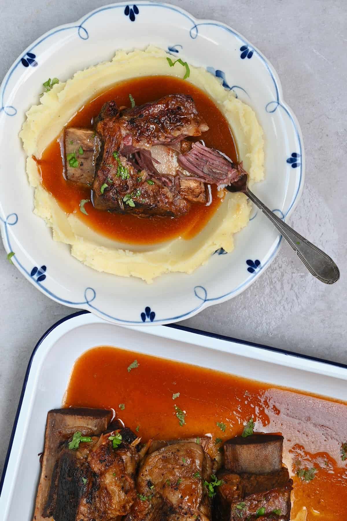 A serving of short ribs with mashed potatoes