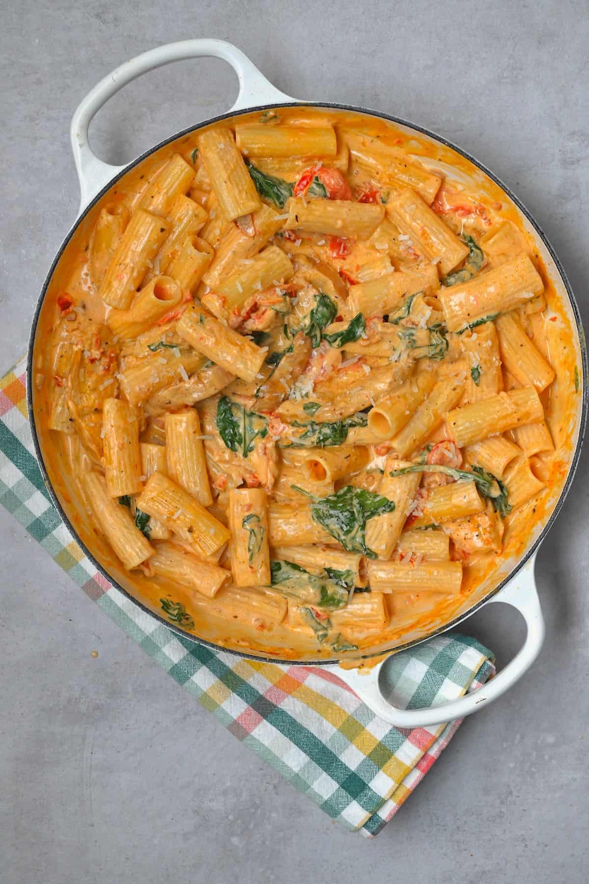 A large skillet with Tuscan chicken pasta