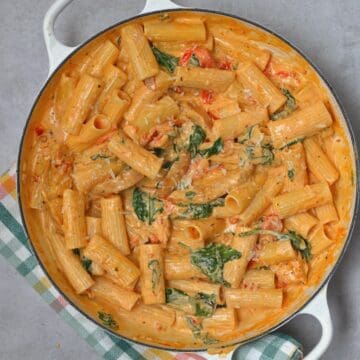 A large skillet with Tuscan chicken pasta