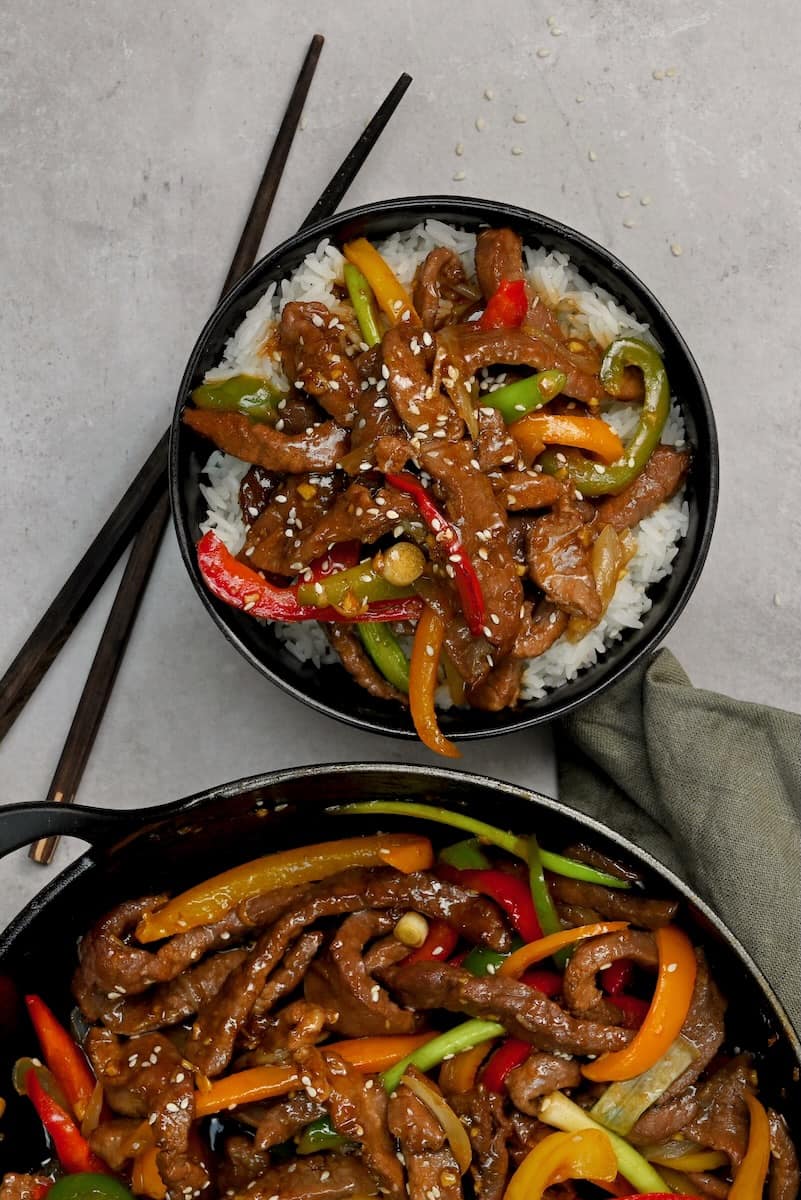 A serving of beef stir fry over rice