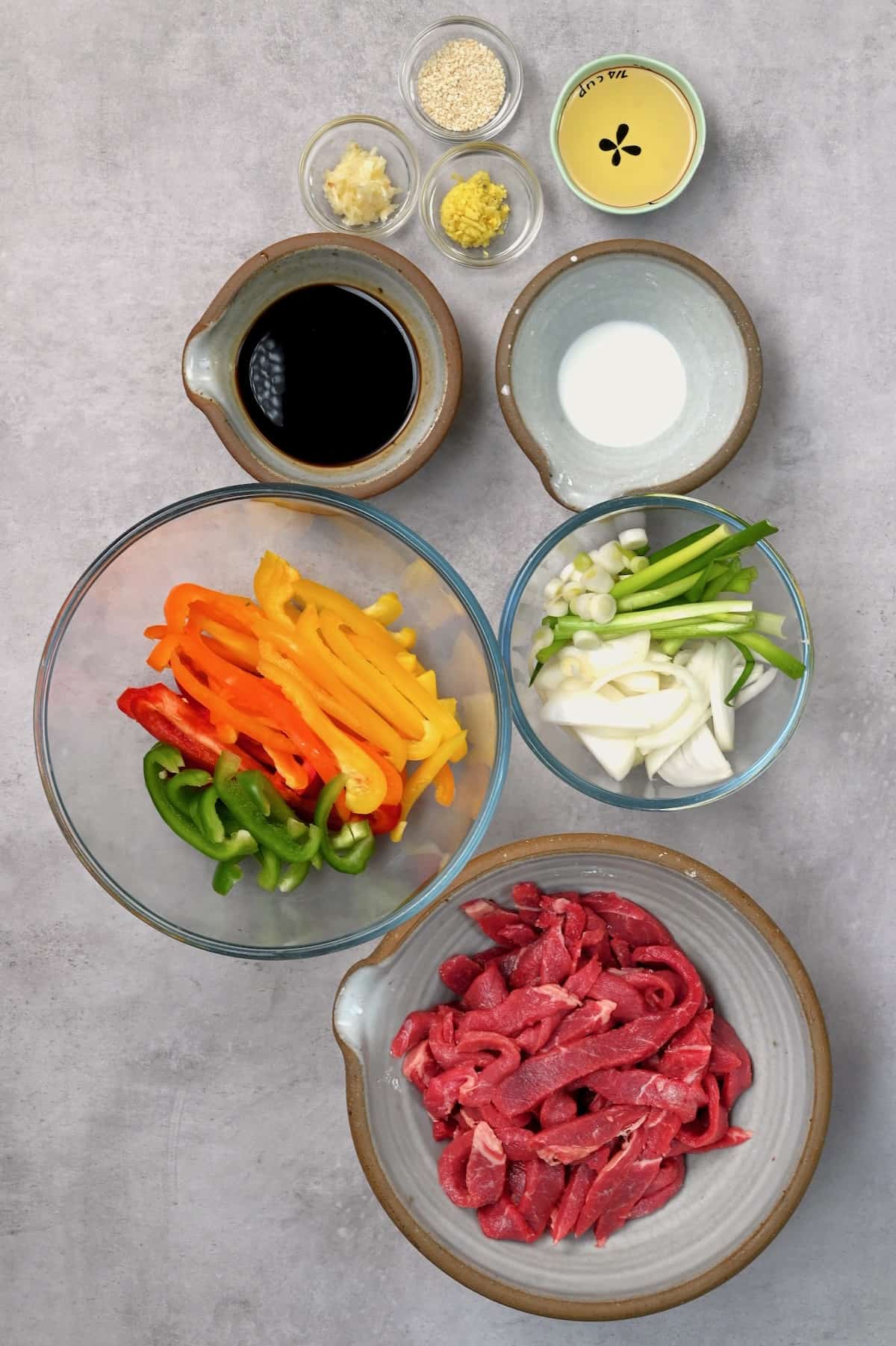 Chopped ingredients and prepared sauces for beef stir fry