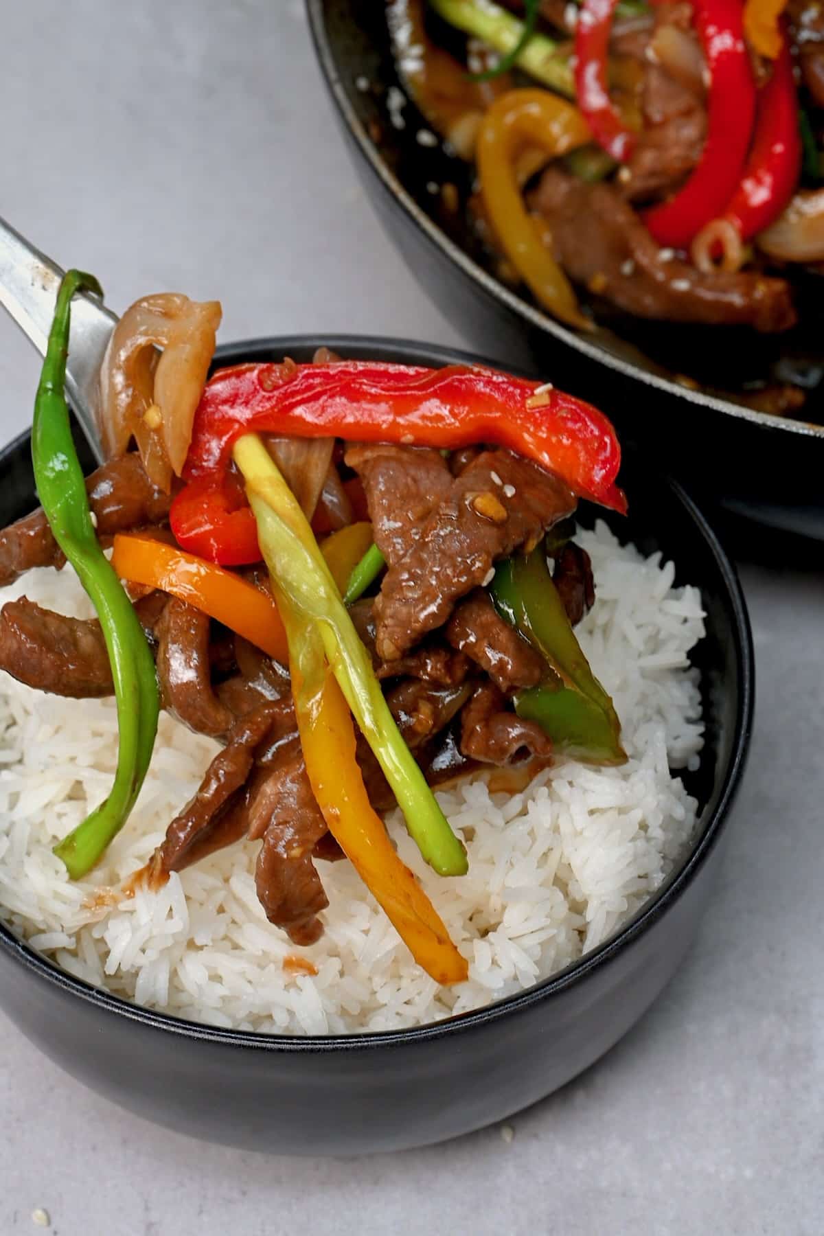 Preparing a serving of rice with beef stir fry