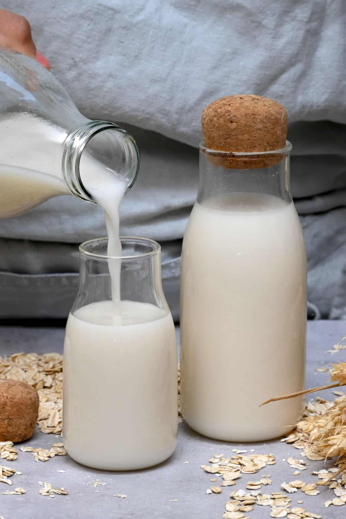 pouring oat milk into a bottle