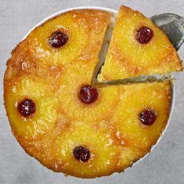 Upside-down pineapple cake with a slice cut off