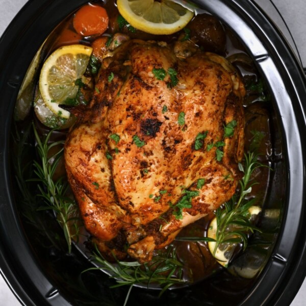 close up of a whole chicken cooked inside a crock pot