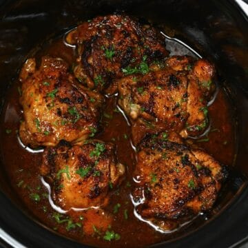 close up of chicken thighs cooked inside a crockpot