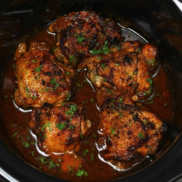 close up of chicken thighs cooked inside a crockpot