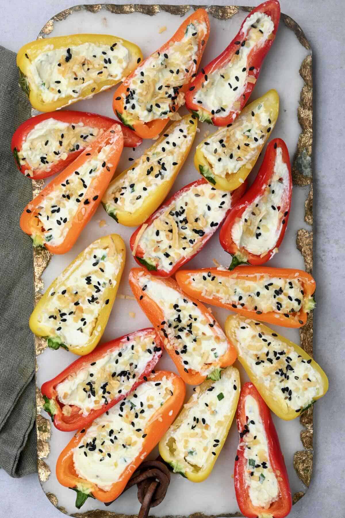 cream cheese stuffed peppers on white marble