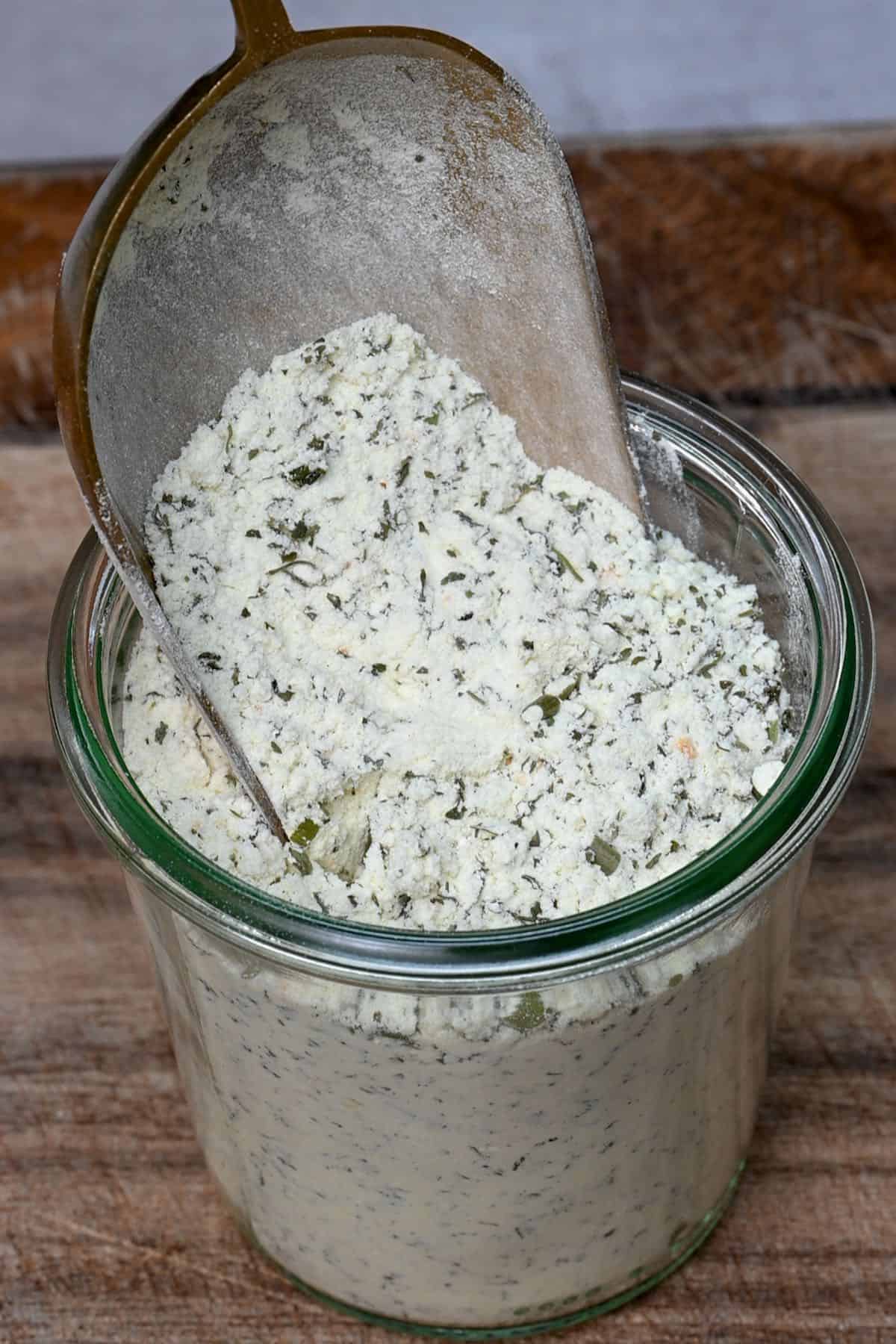 filling a glass jar with ranch dressing mix