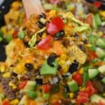 Homemade nachos topped with avocado and tomato slices - 7