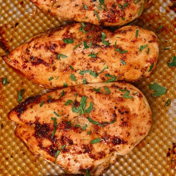 Oven baked chicken breasts topped with chopped parsley