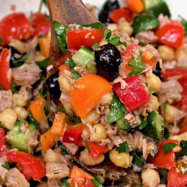 close up of mediterranean tuna salad on wooden spoon